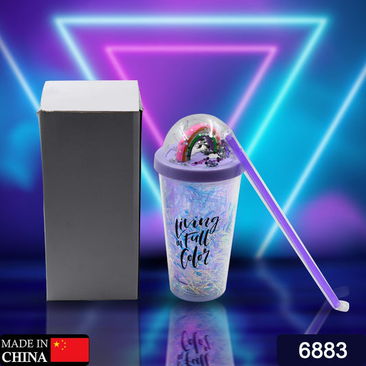 Close-up of a plastic tumbler with LED glow light and straw.