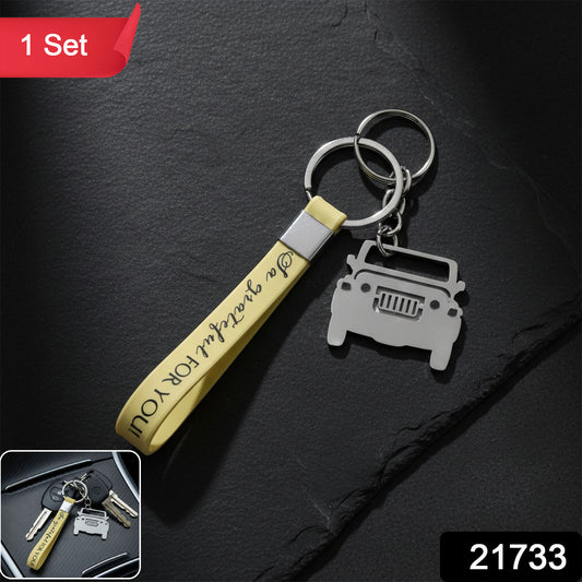 Close-up view of jeep-shaped metal charm on car keychain with soft grip strap