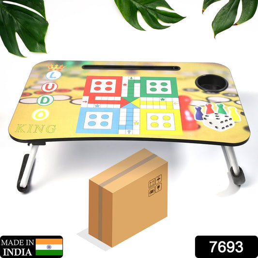 Portable Ludo laptop desk for kids comfortably set up on a bed.