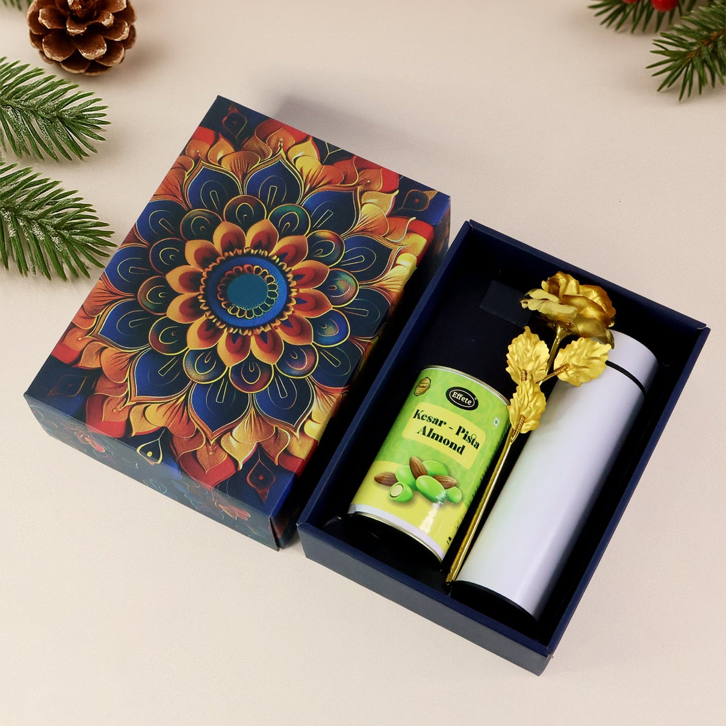Festive kesar pista almonds gift hamper with golden rose and stainless steel bottle.