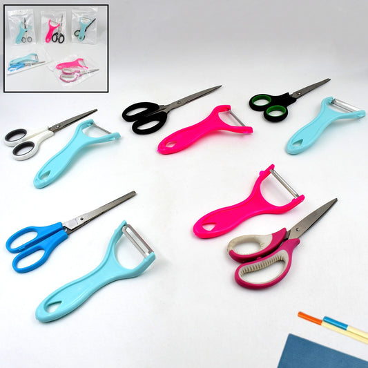 Stainless steel kitchen scissor and vegetable peeler set on a clean surface.