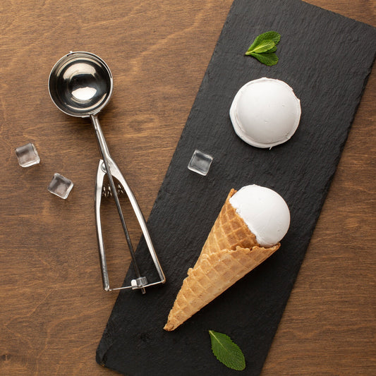 Stainless steel ice cream scoop with trigger release mechanism.