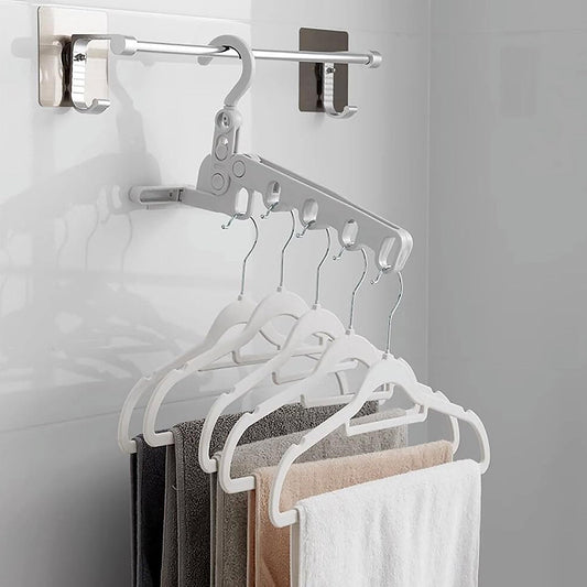 Foldable clothes hanger with 5 holes, shown extended for use in a closet.