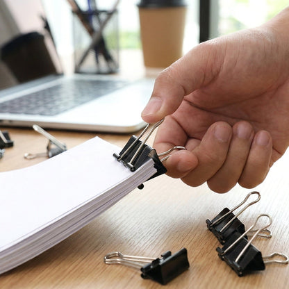 Detailed view of black heavy duty metal binder clips with smooth handles