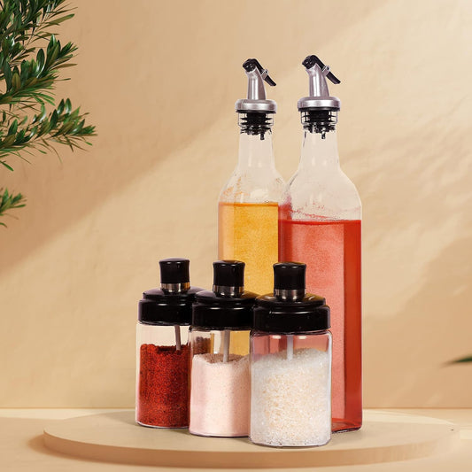  5-piece glass oil dispenser and spice jar set for kitchen storage.