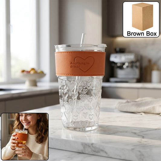 Clear glass drinking tumbler with spill-resistant lid in a modern kitchen setting