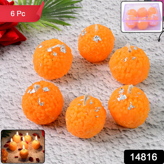 Bright orange laddu-shaped decorative wax candles arranged for Diwali celebration