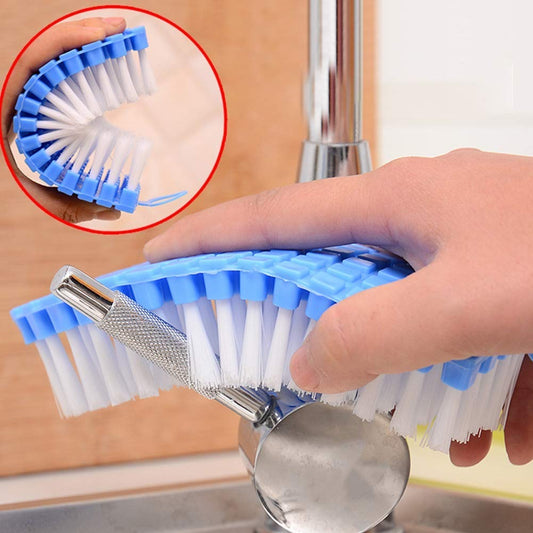 Flexible cleaning brush bent for scrubbing kitchen sink corners.