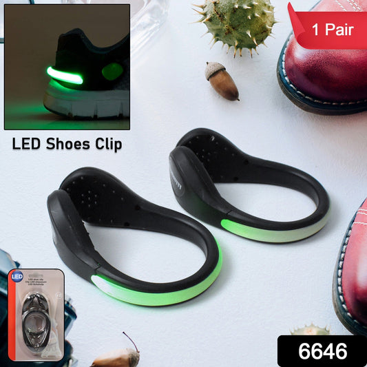 Close-up of a bright red LED shoe clip light attached to a black sneaker.