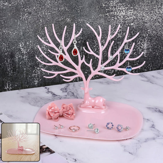 Pink deer-shaped jewelry stand with tree branches for earrings and rings, India