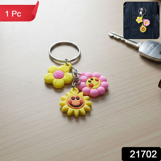 Close-up of flower and smiley face charms on cartoon keychain