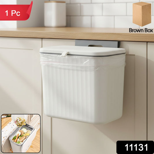 Plastic kitchen dustbin with lid mounted on the wall