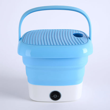 Mini folding washer on a clean background, highlighting its compact size for travel.